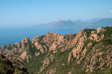 Evening view of the sun-lit mountains and sea - Corsica, Calanche region