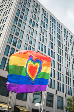 LGBT flag with a heart waving in front of the high building