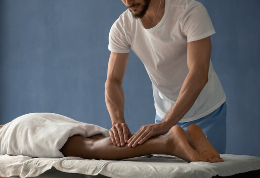 Crop masseur applying pressure to calf muscles