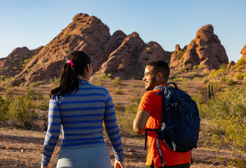two Friends taking rest while Hiking in Southwest Desert landscape