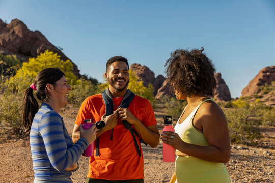 Desert Arid Landscape with three Gen z friends Hiking together 