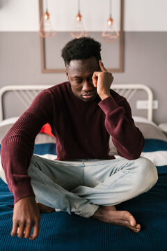 Tired black male suffering from headache