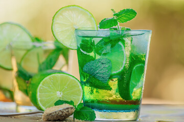 glass of mojito with lime, mint and brown sugar