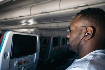 Man watching a movie on the plane