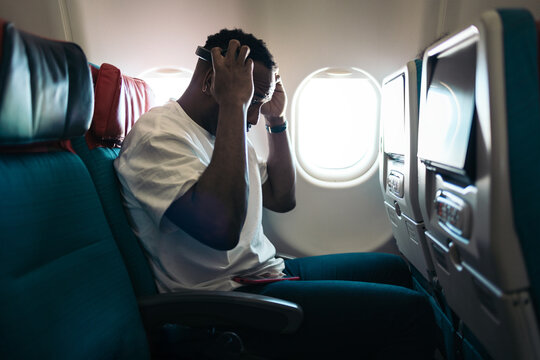 a man listening music during a flight