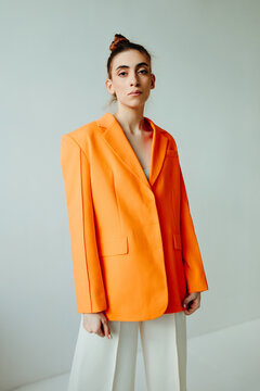 Studio woman portrait in orange suit - Daylight portrait