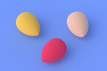 Egg sponges on blue background. Cosmetic accessories. Beauty and fashion. Makeup tools. 3d render