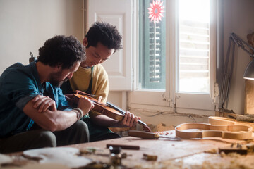 Proud luthiers enjoying the violin created