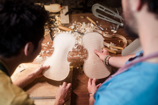 Anonymous violin luthiers comparing pieces