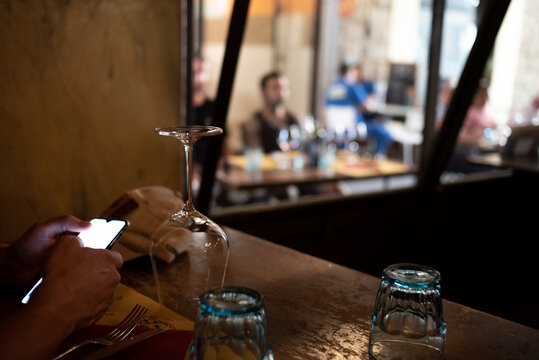 Firenze typical osteria man scrolling on phone