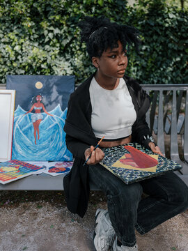 A young artist painting plein air