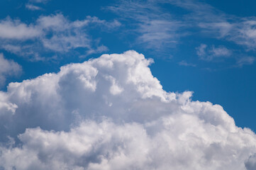 Naklejka na ściany i meble Bright sunny sky with fluffy cumulus clouds.