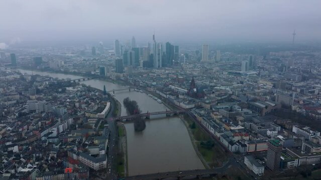 Aerial panoramic view of large city. Bridge over wide river connecting boroughs on banks. Group of skyscrapers in business centre. Frankfurt am Main, Germany