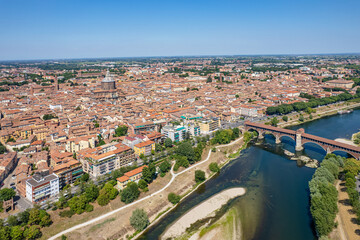 Fototapeta na wymiar Aerial view of Pavia and the Ticino River, View of the Cathedral of Pavia, Covered Bridge. Lombardia, Italy