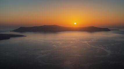 Amazing landscape with a beautiful sunset on Thirasia island viewd from Santorini, Greece - obrazy, fototapety, plakaty