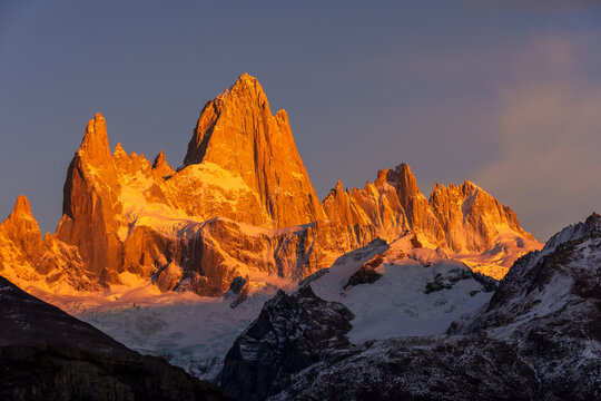 The first rays of sunlight shine on the Fitz Roy mountain, creating hues of red and orange. Fitz Roy is located near the village of El Chalt&eacute;n in the Patagonia region of Argentina.