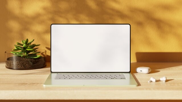 Laptop with blank screen on wood table. Aesthetic workplace.  