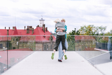 Lesbian couple in casual apparel hugging during date 