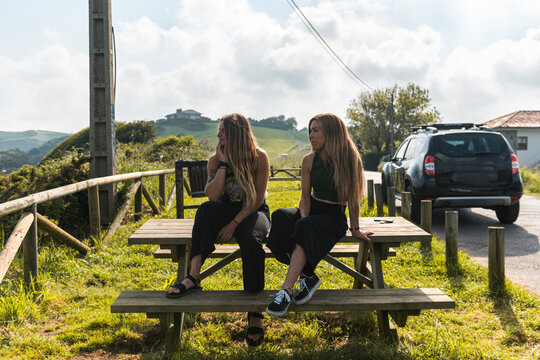 Women friends watching swell from the beach