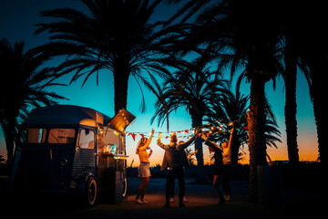 Friends dancing during party on beach