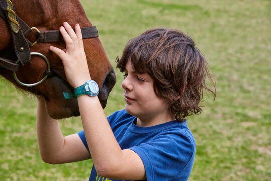 Young farm boy with his pet horse