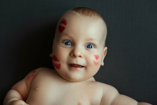 cute baby in prints of red lipstick