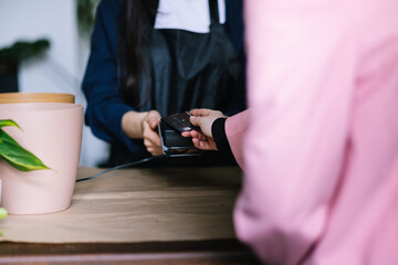 Anonymous person buying goods in shop 