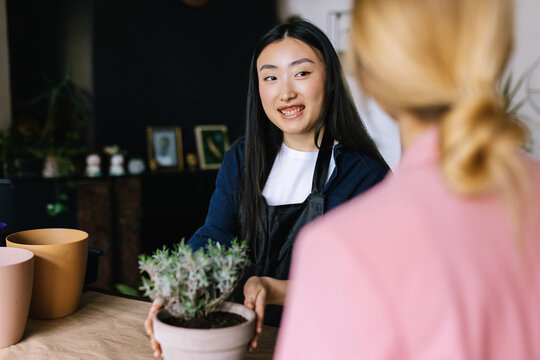 Saleswoman paying attention to customer and suggesting goods 