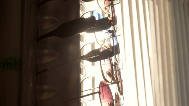 row of sunglasses on display in an optical shop - trade, sale