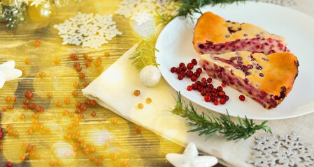 Traditional homemade Christmas cake on a white plate festive dessert with cranberries on the background of Christmas decorations