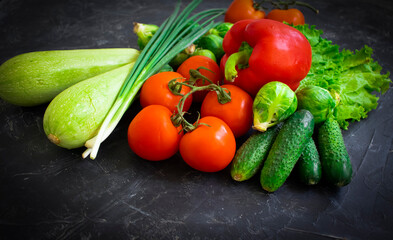 Fresh different vegetables on dark background