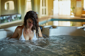 closeup of a beautiful woman relaxing in a hotel jacuzzi during her vacation