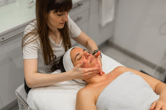 woman receiving facial massage