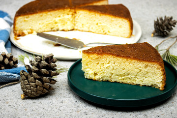Homemade dessert rum baba with apricot jam decorated with pine cones