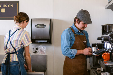 Baristas behind bar making coffee