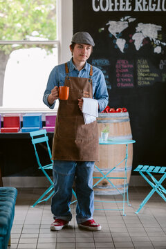 Handsome Barista walking through coffee boutique shop
