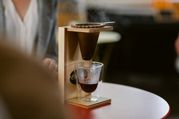 Dripping boiling water over ground coffee on drip coffee maker