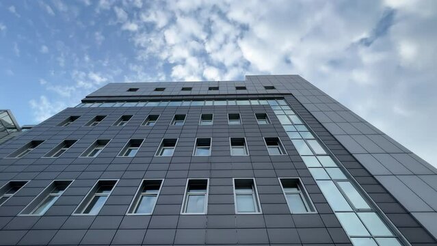 Modern factory office building, covered with metal building cladding. Bottom up view. Extreme wide angle shot