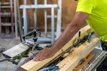 master carpenter polishing some wooden slats