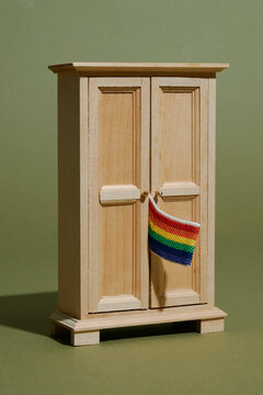 gay pride flag peeking out of a closet