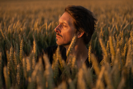Concerned Male in His Thirties is Looking At the Light Away At Sunset