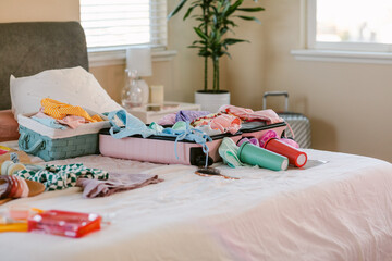 Summer sorted clothing on bed 