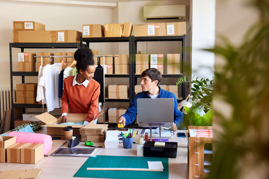 Colleagues talking during work in delivery office