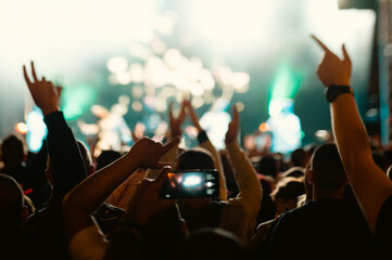 Anonymous crowd at a concert. People enjoying live music. Music stage.