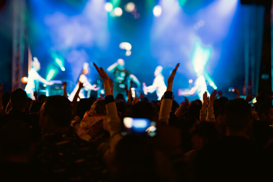 Anonymous crowd at a concert. People enjoying live music. Music stage.