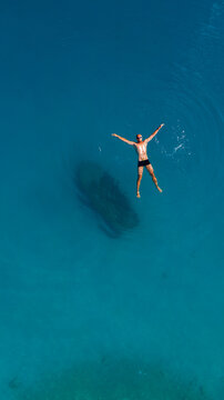young athletic man relaxing in turquoise water