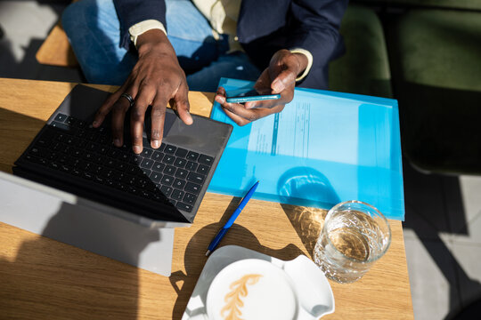 Close Up Of Using Mobile Phone While Working