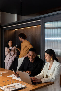 Diverse employees working and taking break in office