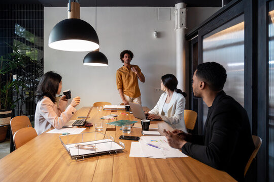 Diverse businesspeople listening to black colleague