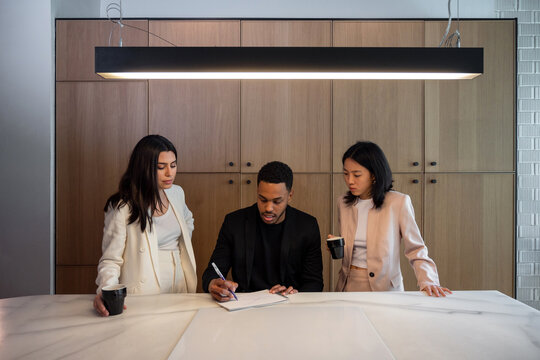 Diverse designers working on project in kitchen